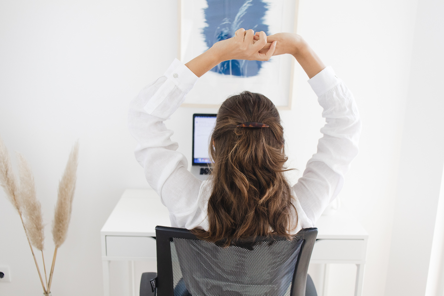 Woman Stretching Her Arms while Working at Home